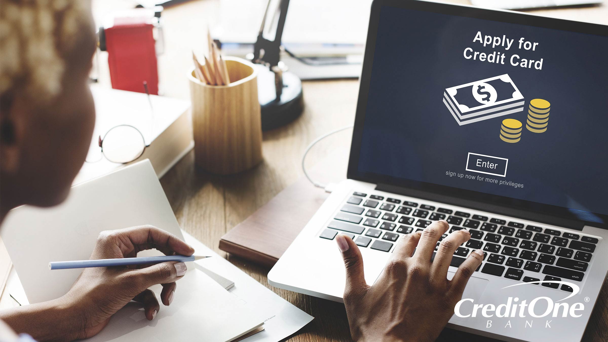 A woman uses a laptop to apply for a credit card, even though she may have no or bad credit history.